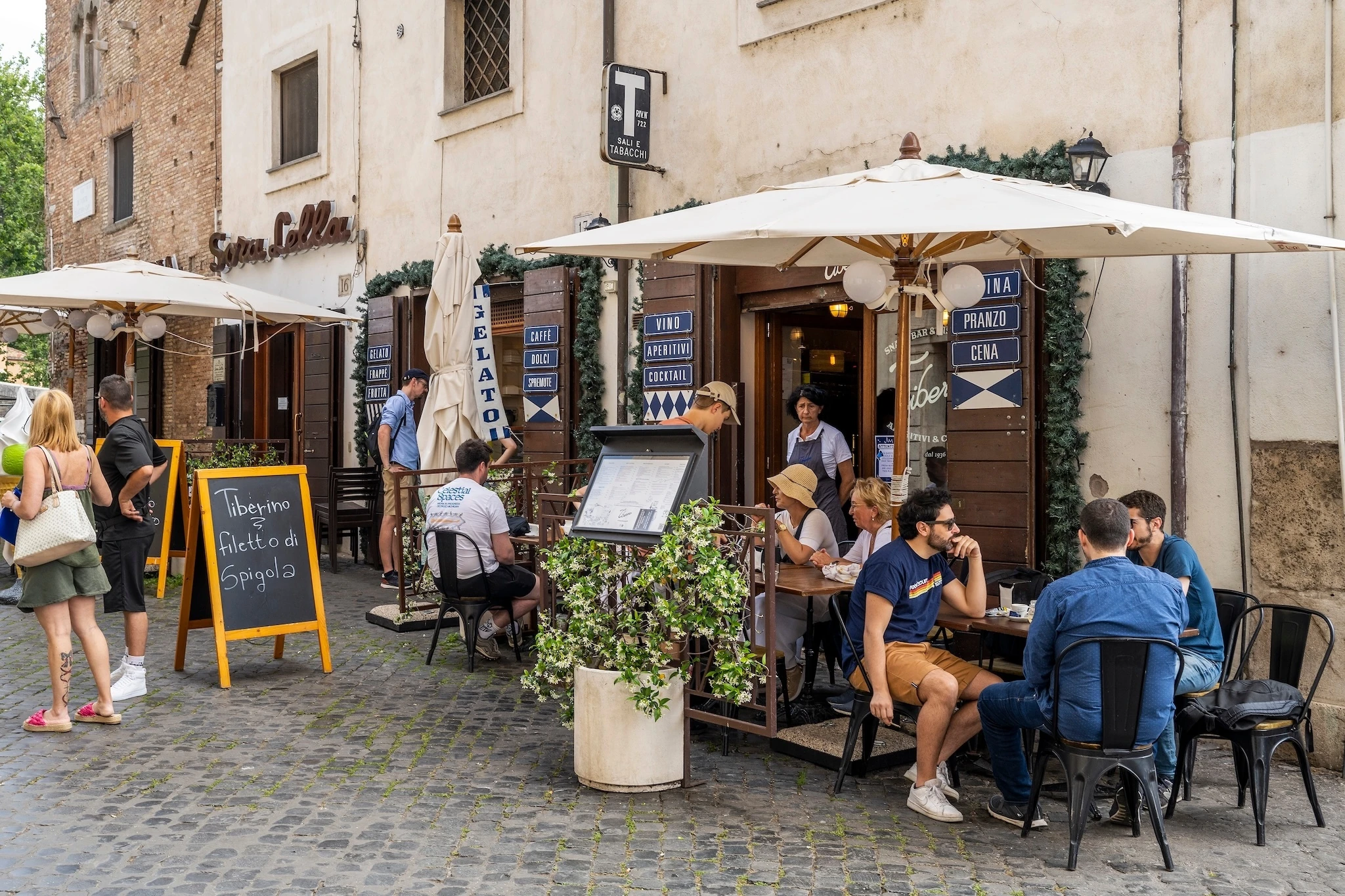 Sidewalk cafe restaurant in a cobbled street of Trastevere district