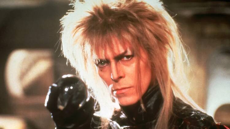 Close-up of a costumed performer holding a crystal ball in a fantasy-themed setting
