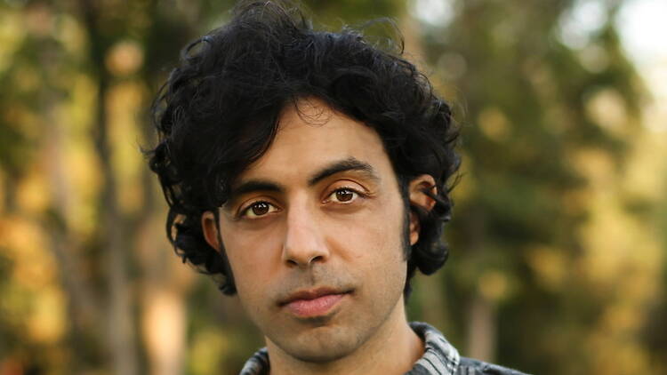 A close-up of a person looking at the camera outdoors. A close-up of a person looking at the camera outdoors.
