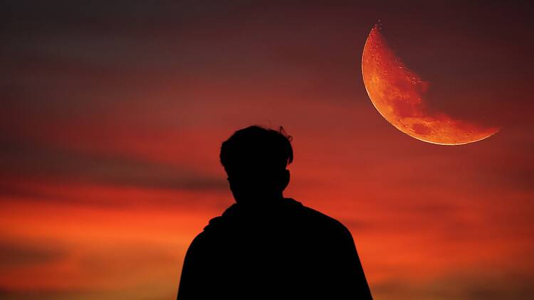 Blood moon during sunset