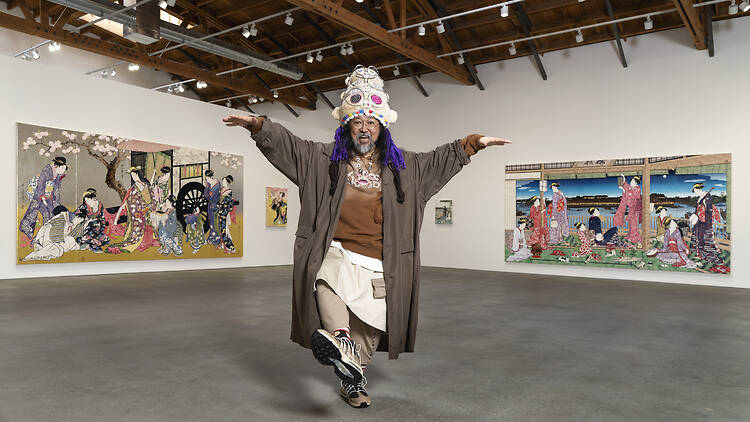 Takashi Murakami artist Takashi Murakami with his artwork in the background