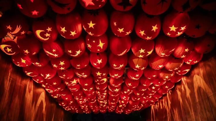 Magic of the Jack O’Lanterns A walkway with jack-o-lanterns overhead.