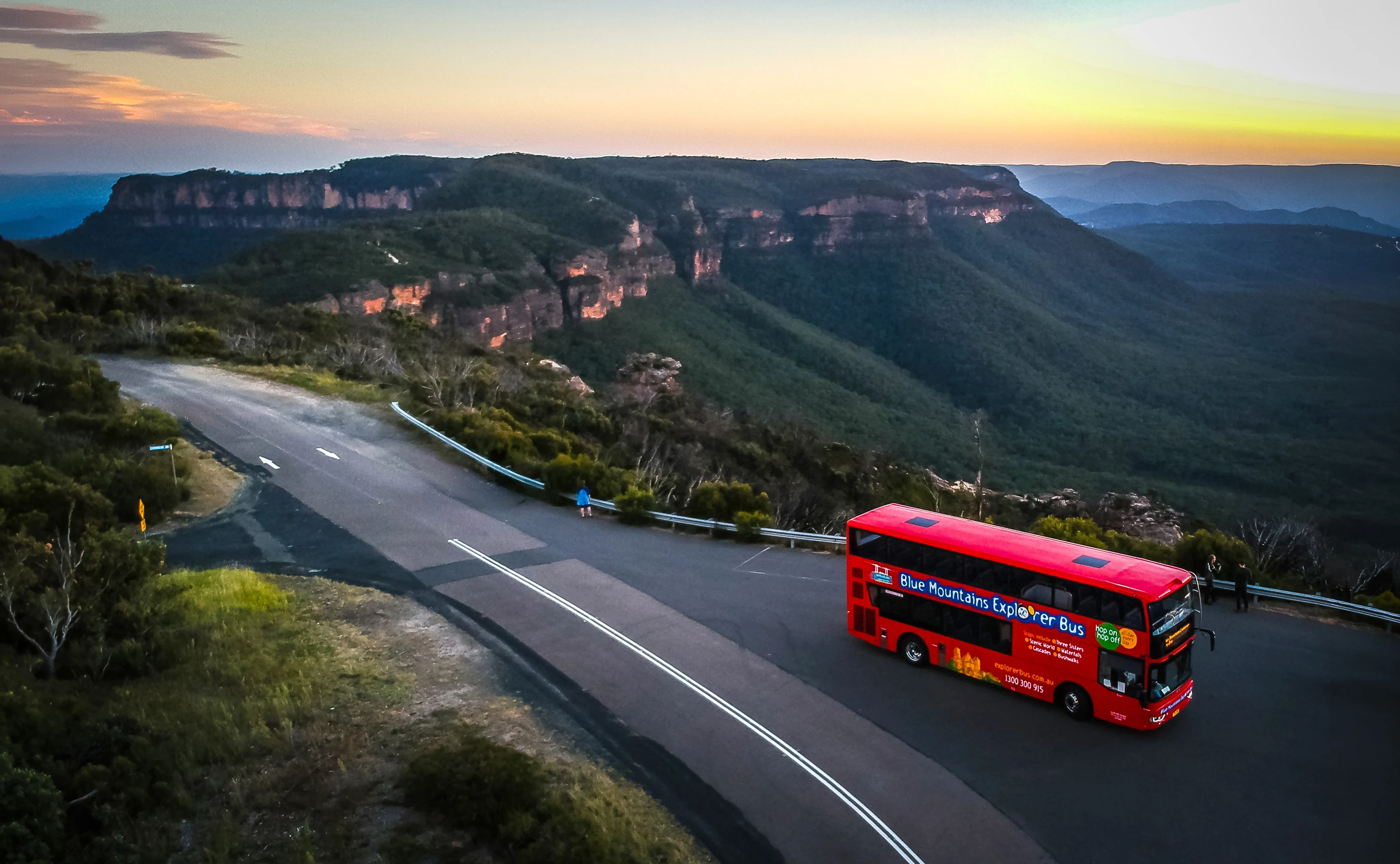 The Blue Mountain Explorer Bus driving on a scenic road