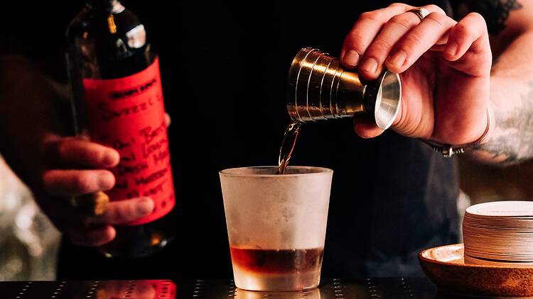 A person making a cocktail.
