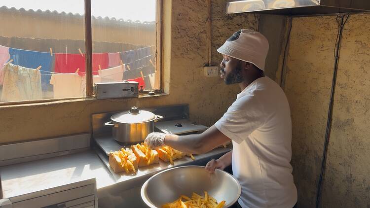 Founder of Eli Foods and Event, Mfundo Gasa, preparing kotas Founder of Eli Foods and Event, Mfundo Gasa