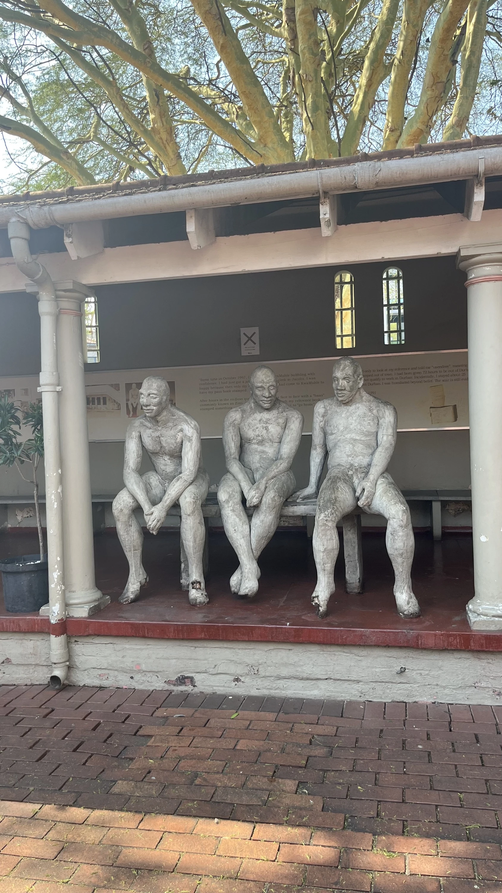 The three figures in Ledelle Moe's The Shadows of the Past represent migrant workers.
