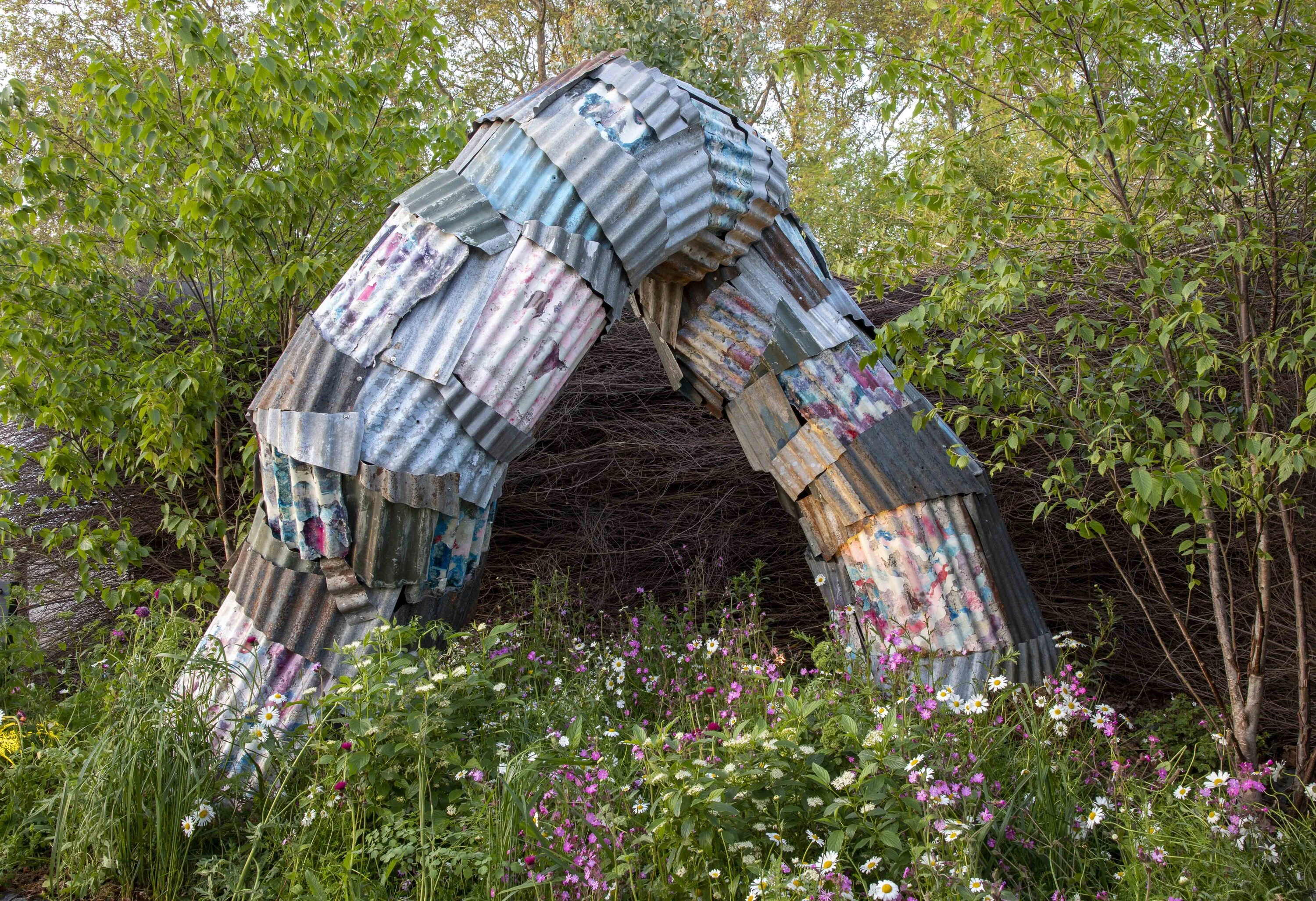 Sculpture of a giant worm made of discarded materials