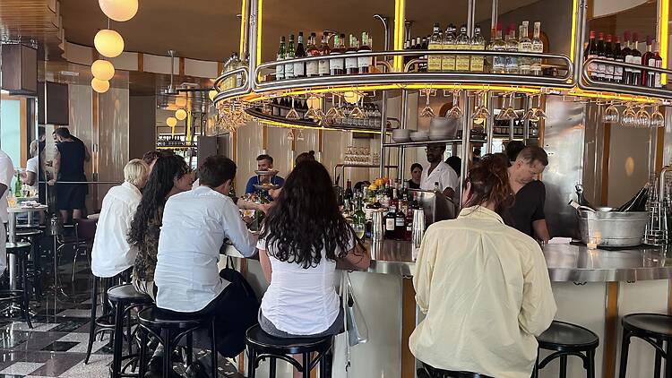 A group of people around the center oyster bar