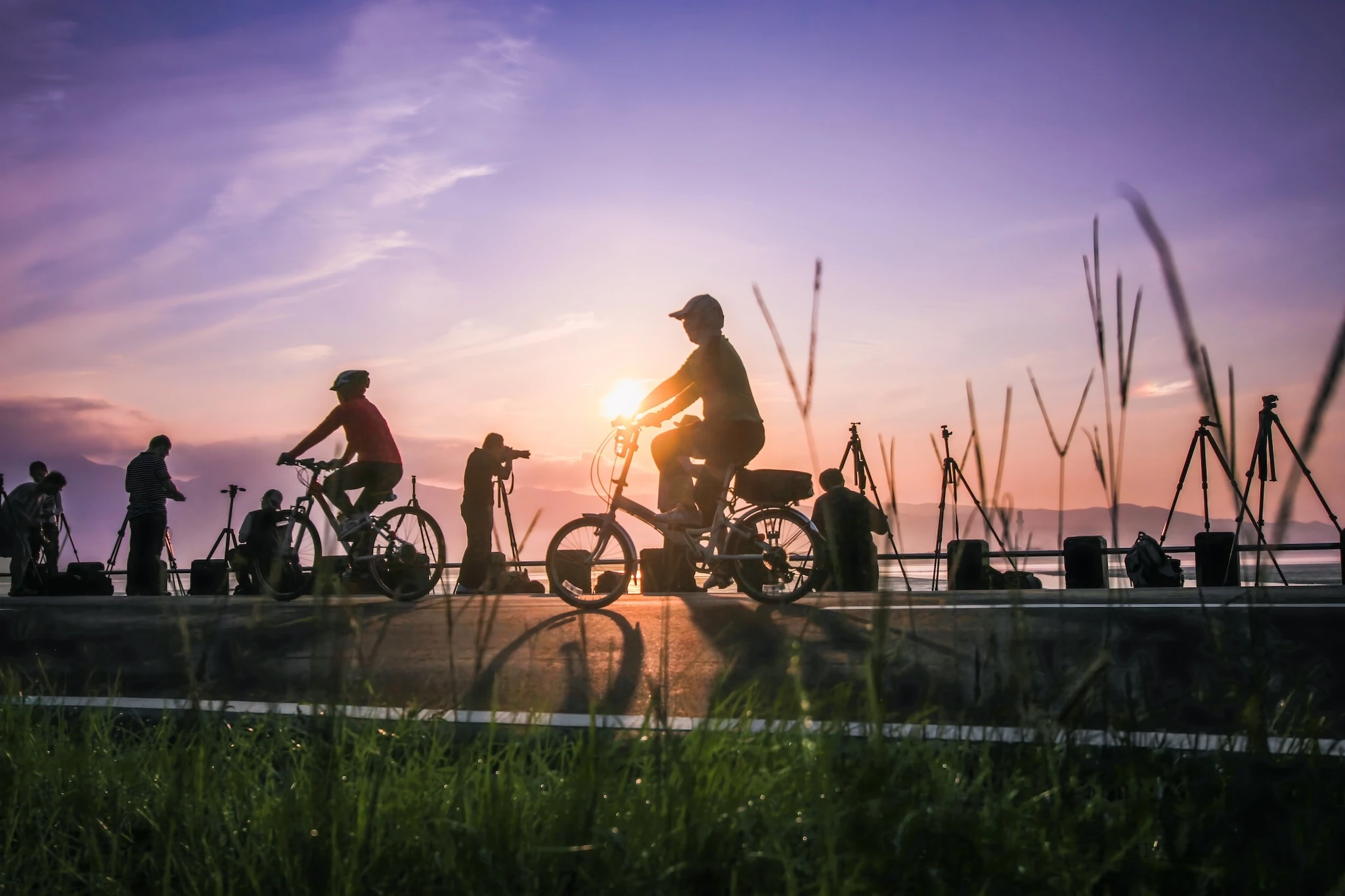 Cyclists enjoying sunrise at Wugu Wetland, New Taipei City