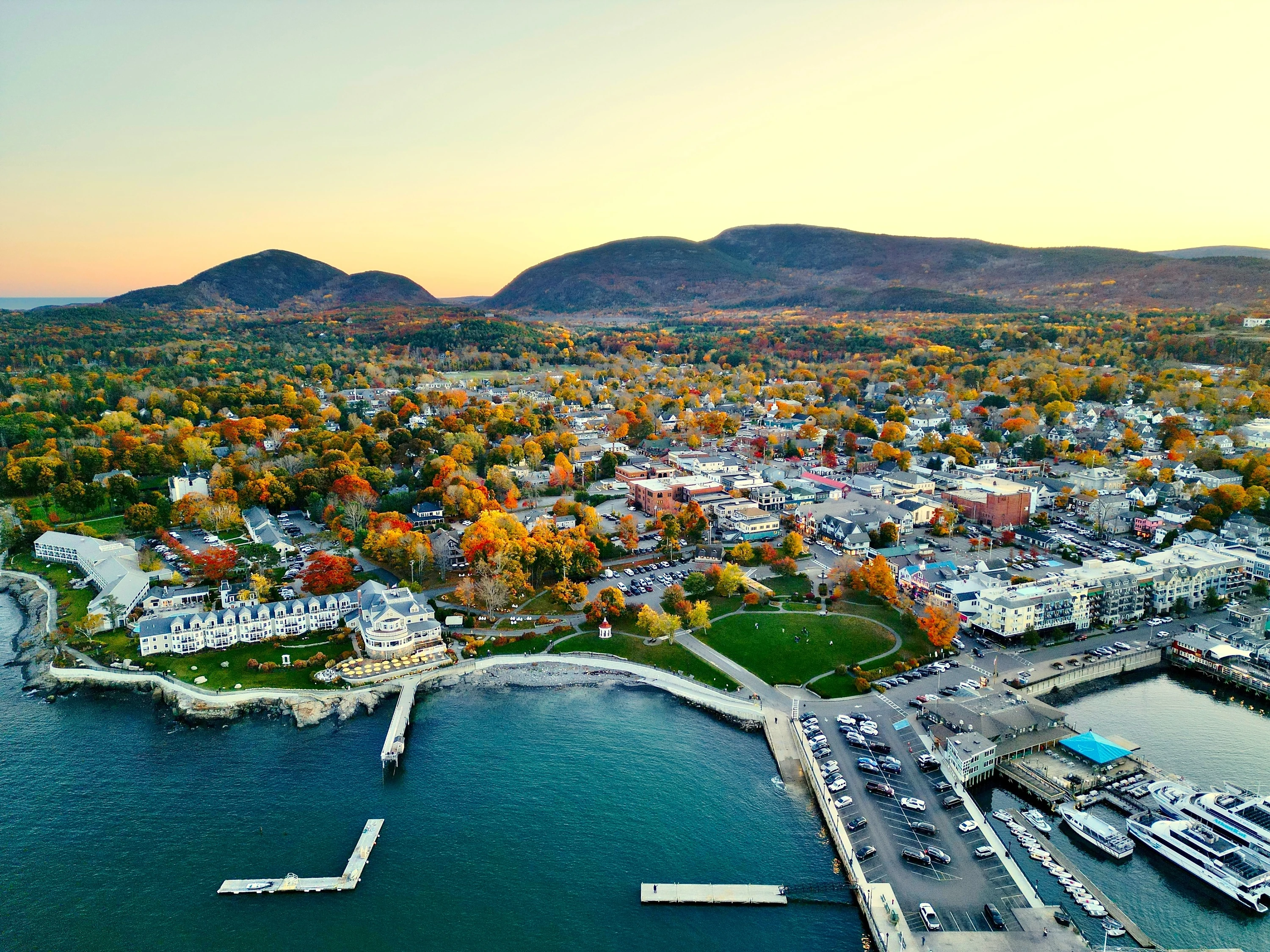 Aerial view of Bar Harbor Maine with the Mountains of Acadia National Park in the background during fall season