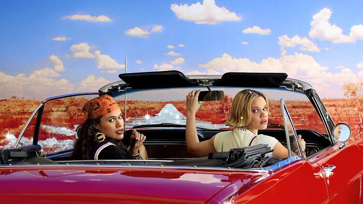 Ruby Henaway and Lila McGuire in Dirty Diamonds two women in a red convertible looking back