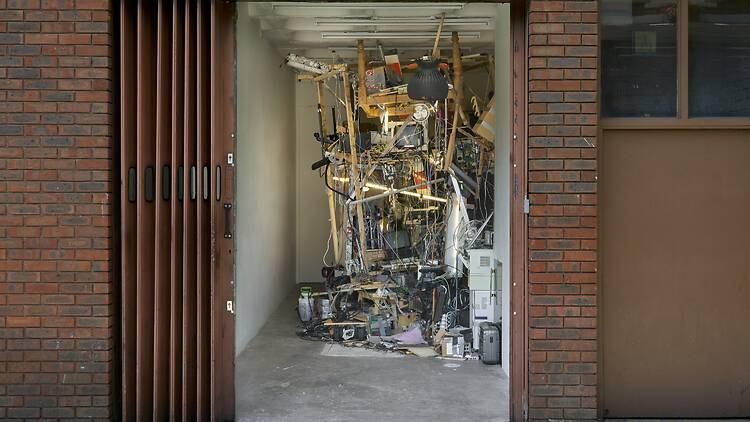 A mixed media artwork comprising furniture, wired and electronics A mixed media artwork comprising furniture, wired and electronics