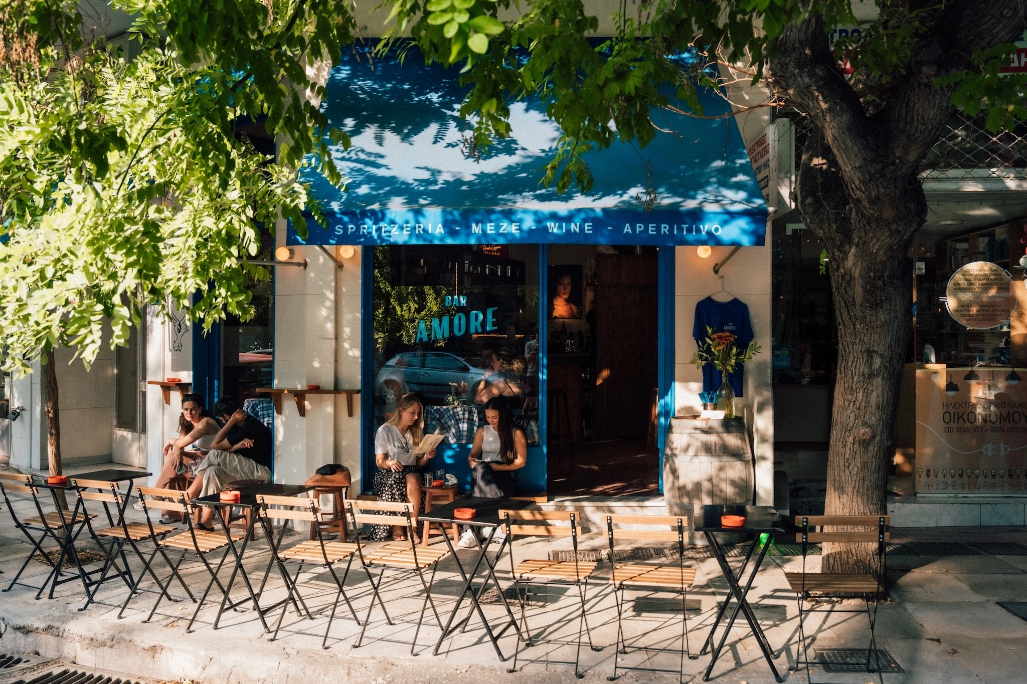 People sitting outside Bar Amore in Athens on a sunny day