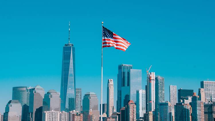 American flag with the skyline of New York in the background American flag with the skyline of New York in the background