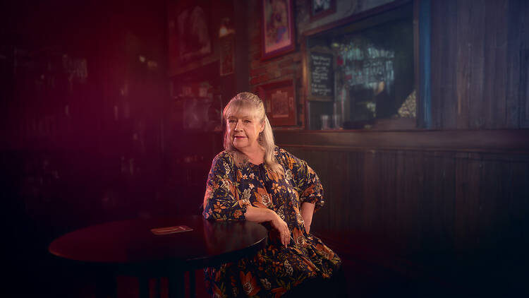 woman in printed dress sitting on chair