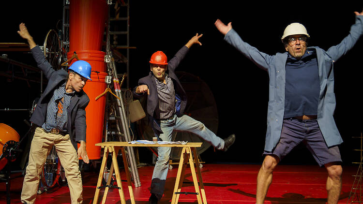 Tinker Tales three men in hard hats with arms akimbo