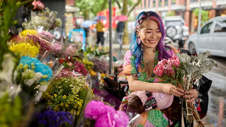 The Spring Series at Queen Victoria Market featuring a lady shopping for fresh blooming florals.