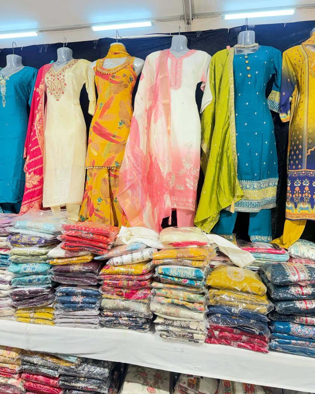 There's a variety of beautiful clothing for sale. 