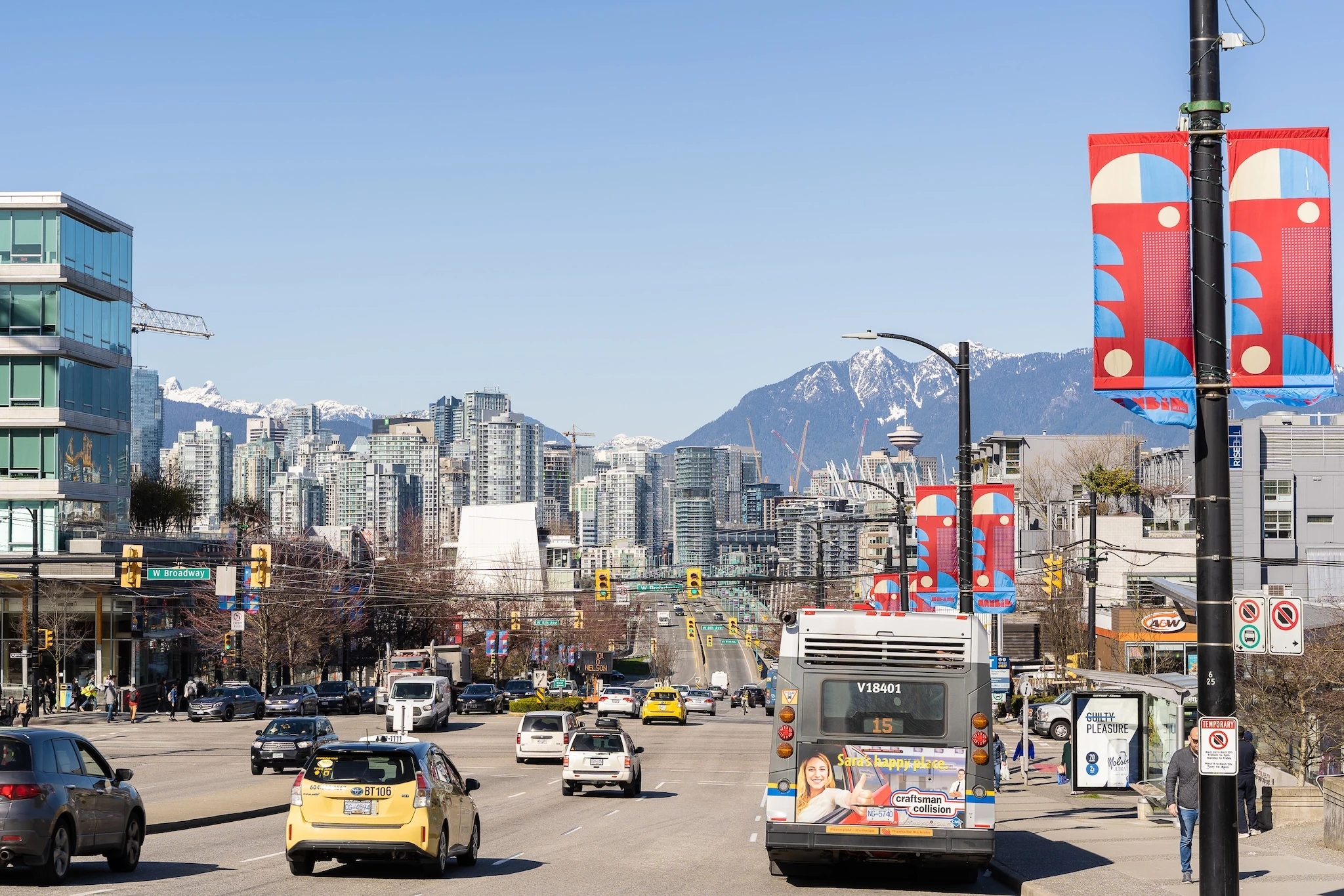 View of downtown Vancouver with skyscrapers, Vancouver lookout and mountains over Cambie Bridge from Cambie street in Mount Pleasant