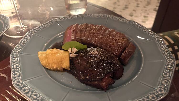 Duck prepared two ways on a blue plate