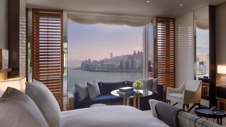 A bedroom with a city view at Rosewood Hong Kong
