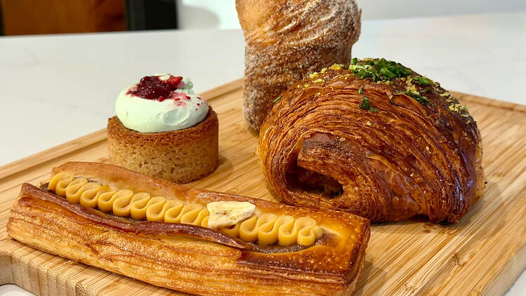 Four pastries on a cutting board.