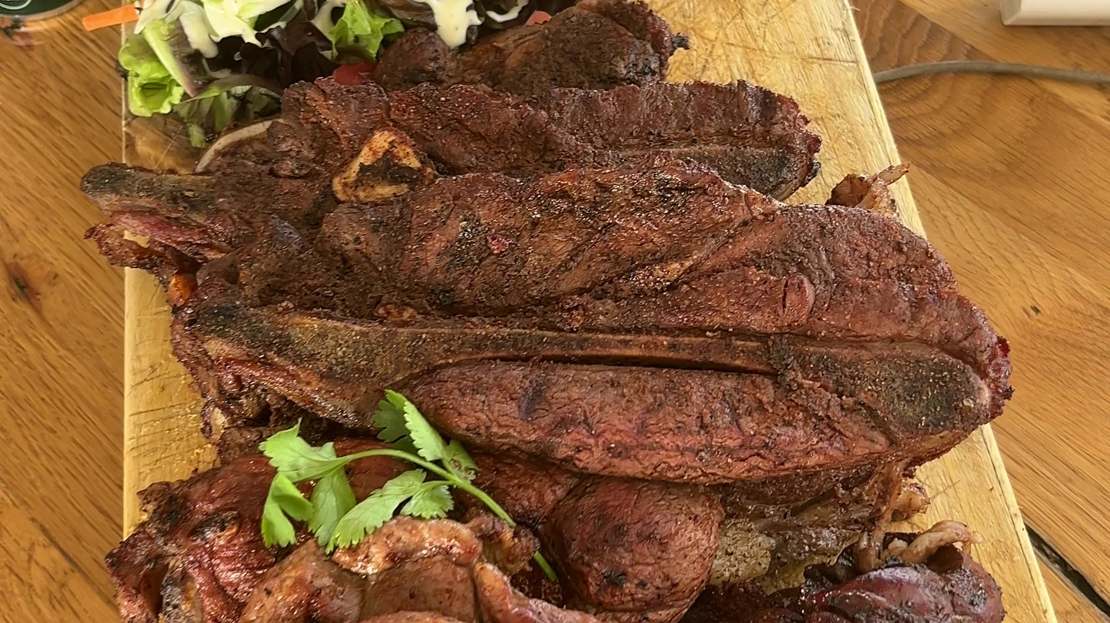 Lunch arrived on a wooden board piled high with braaied meat and salad.