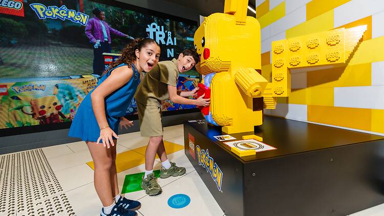 Kids at the LEGO® Pokémon™ SMART Play™ experience available in-store