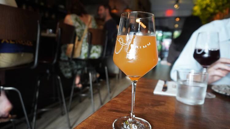 A beer in a glass that says Grimm
