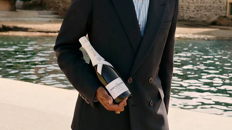 Pharrell Williams holding a bottle of his collaboration sip, Moet Ice x Pharrell Williams Pharrell Williams holding a bottle of his collaboration sip, Moet Ice x Pharrell Williams