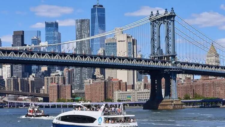 A crowded NYC Ferry travels on the East River A crowded NYC Ferry travels on the East River