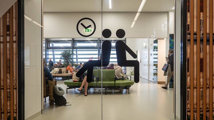 People sitting in an airport lounge at the Vienna International Airport People sitting in an airport lounge at the Vienna International Airport