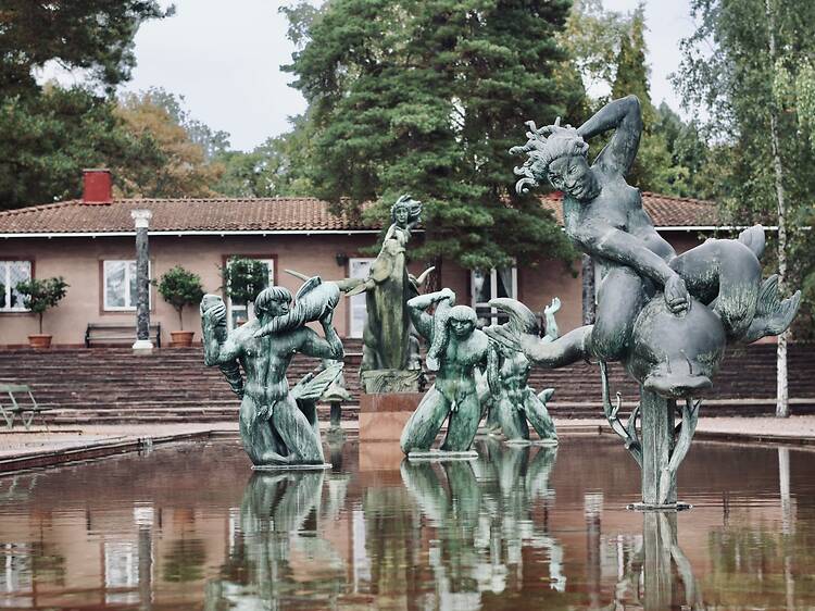 Millesgården Art museum in Lindingö , Sculpture Park in Stockholm Bronze sculptures standing in a reflecting fountain pool at Millesgården in Stockholm with the historic main building in the background