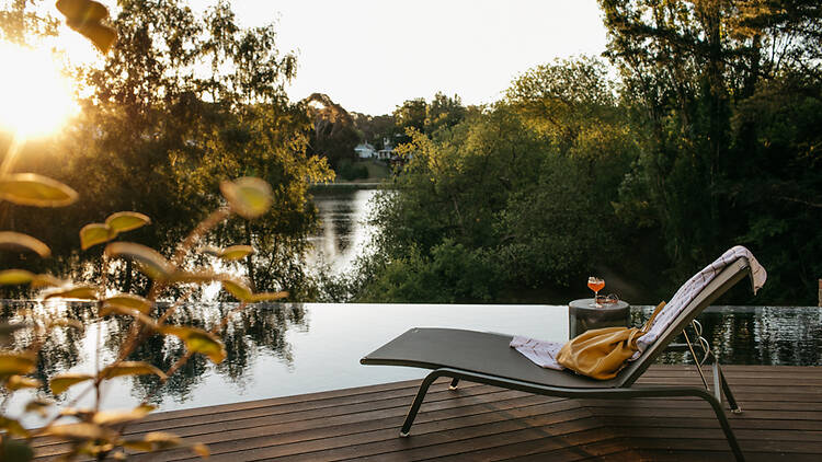 A sun lounger by an infinity pool.