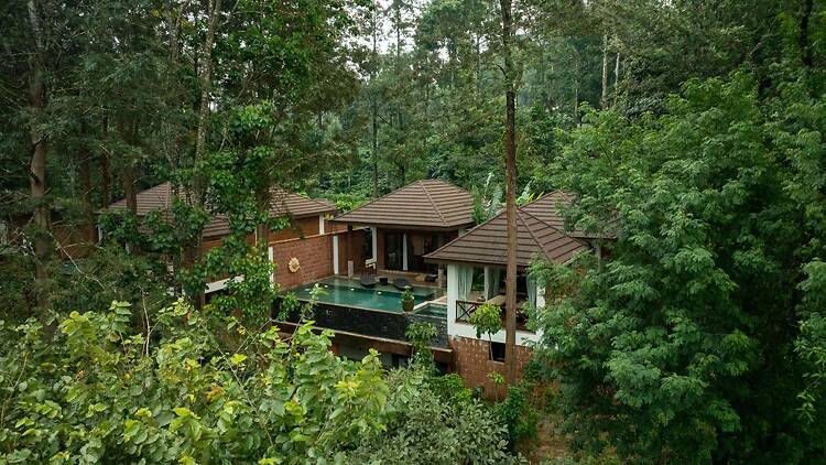 The Leela Coorg is surrounded by coffee plantation and forests