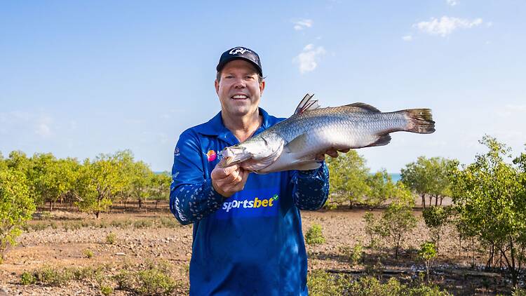 Million Dollar Fish Man holding fish