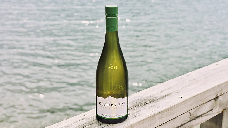 Cloudy Bay sauvignon blanc A bottle of Cloudy Bay Sauvignon Blanc 2026 on a wooden rail above the water