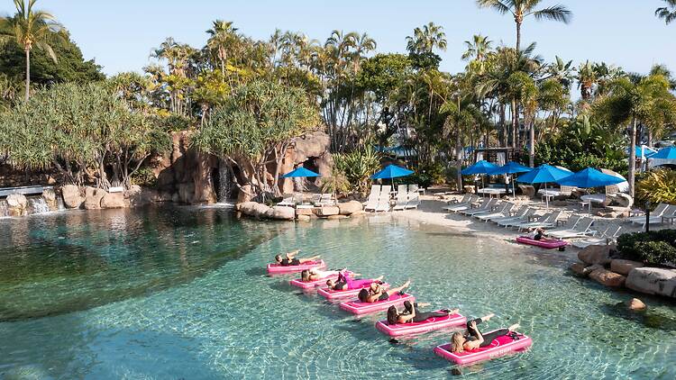 People doing pilates on blow-up mats on the water