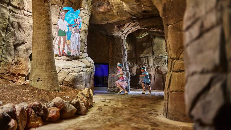 kids playing in a network of fake caves