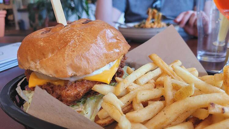 A fried chicken burger with chips