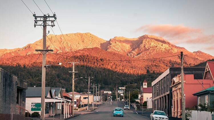 Queenstown Car driving down street with mountain in background