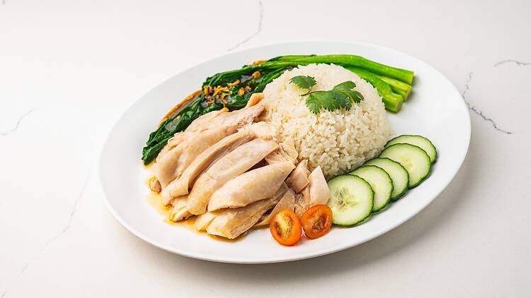 Hainanese chicken rice on a white plate