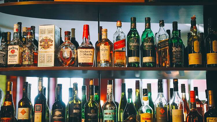 Shelves filled with assorted liquor bottles Shelves filled with assorted liquor bottles