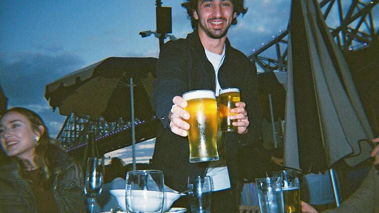 man in black suit holding beer mug