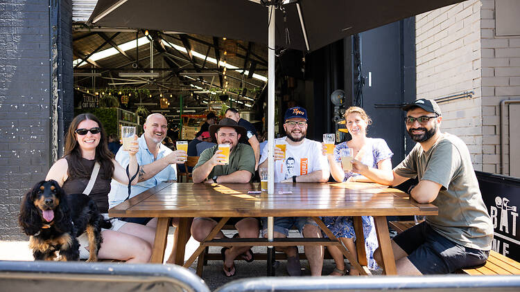 Batch Brewing a group of men and women and a dog outside drinking beer