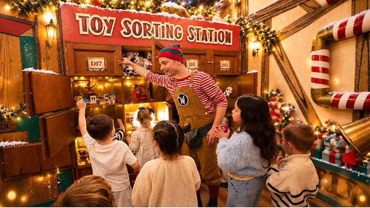 Wundrful World of Christmas santa's elf helps kids at the toy sorting station