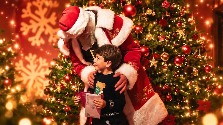 Santa at Wundrful World of Christmas Santa greets a child at Wundrful World of Christmas
