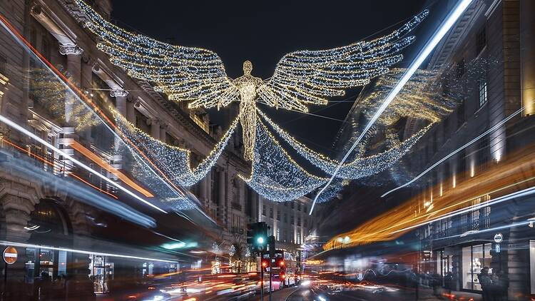 Christmas time on Regent Street at night, London, UK. The cars and buses create light trails