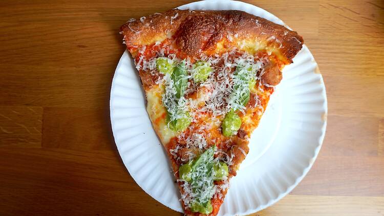 A slice of The Metro with chicken cutlet and garlic pesto cream