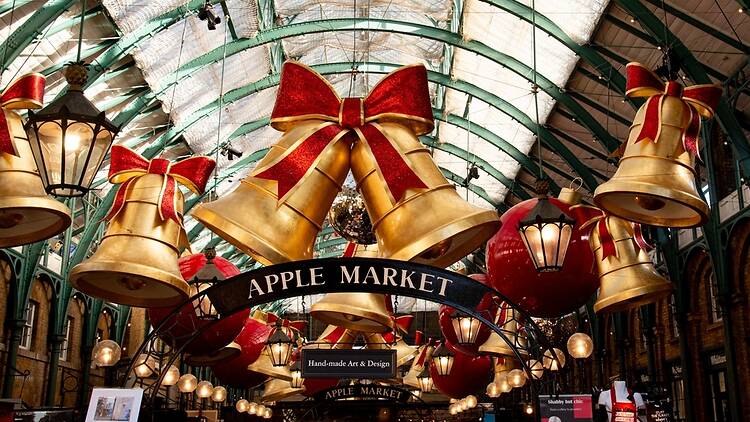 Festive golden bells and red Christmas ornaments decorating historic covent garden market